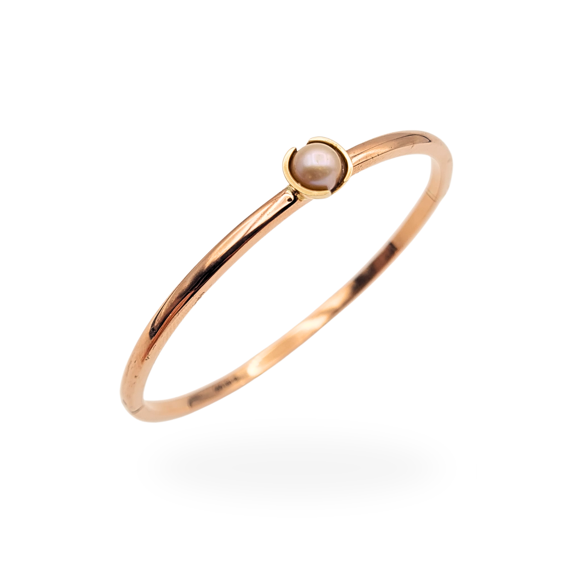 9ct rose gold hinged bangle featuring a single central pearl approximately 6mm in size, slim 3mm band with polished finish, measuring 6.75 inches internal circumference, fully British hallmarked with secure push button clasp and elegant minimalist design