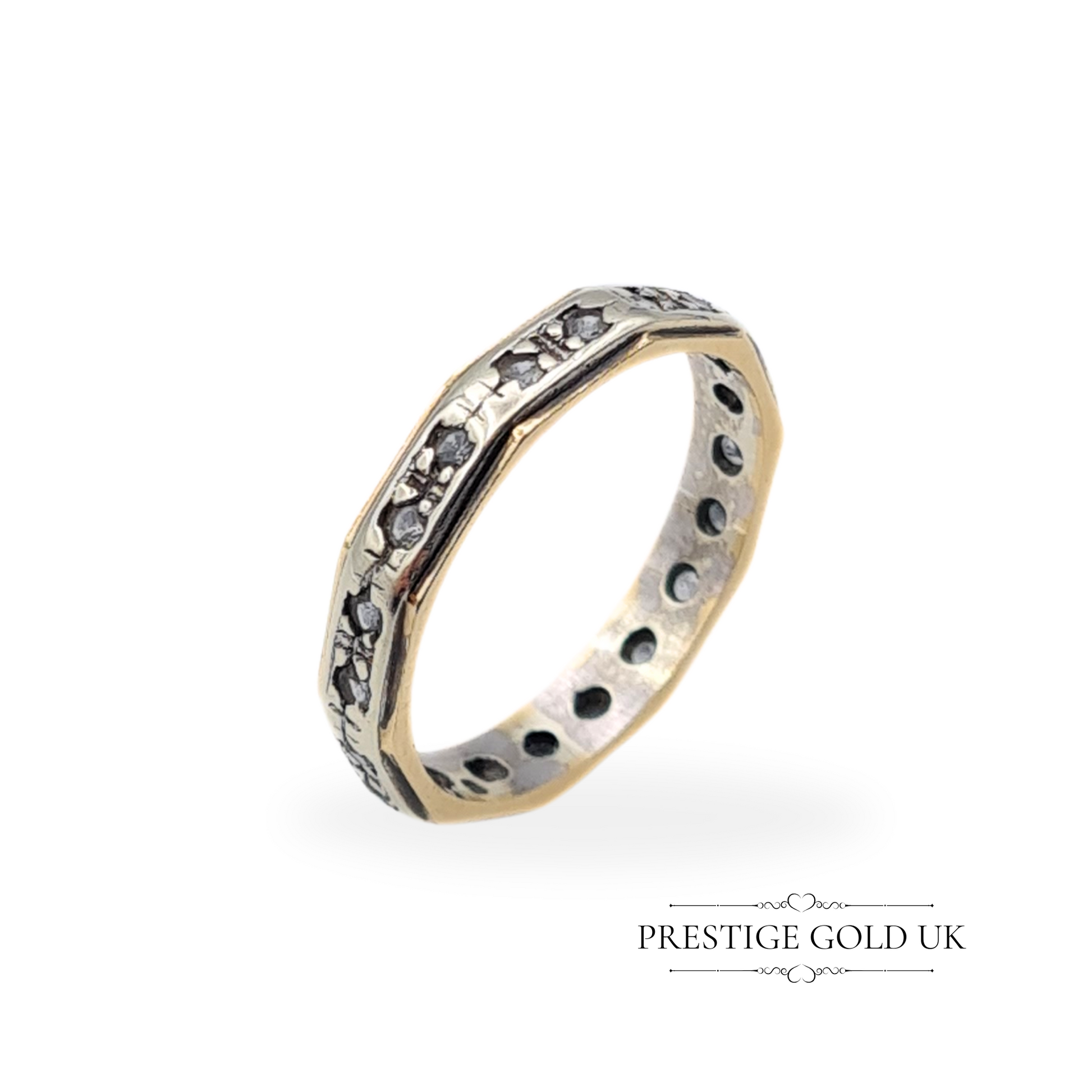 Vintage 9ct white and yellow gold ring with an octagonal shape and spinel stones, featuring a detailed eternity band design.