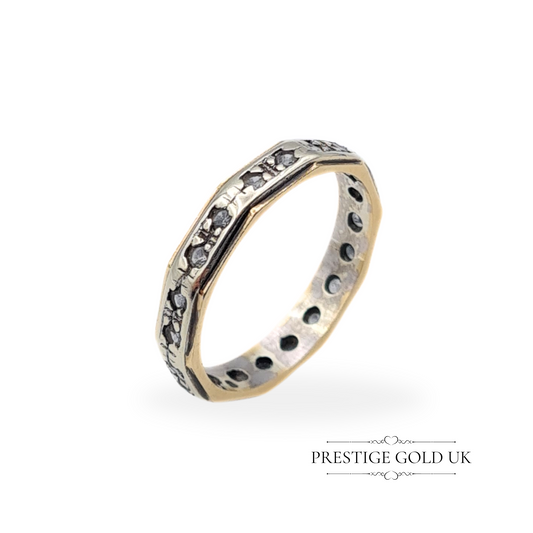 Vintage 9ct white and yellow gold ring with an octagonal shape and spinel stones, featuring a detailed eternity band design.