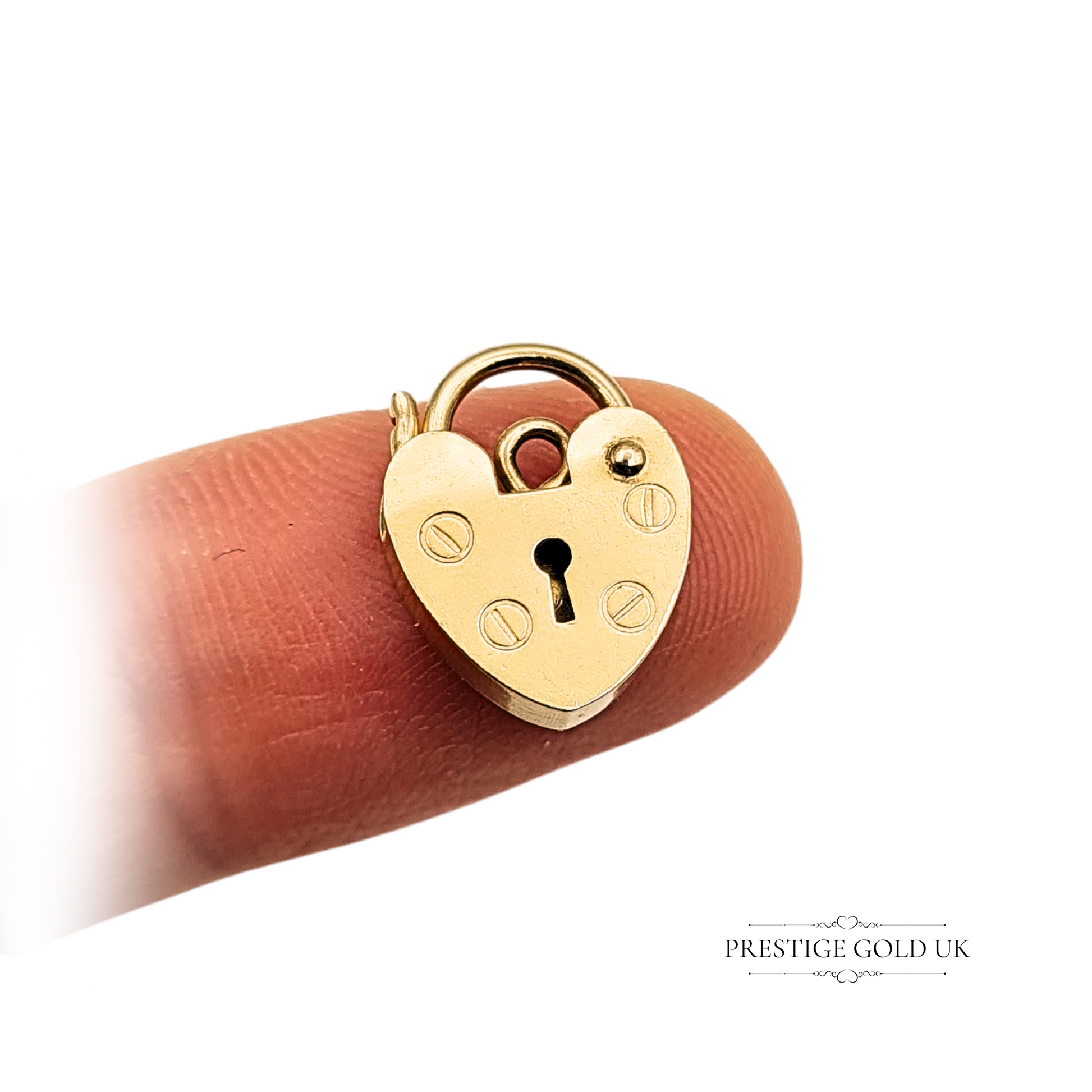 Tiny 9ct gold heart padlock charm, hallmarked London 1989, weighing 0.80g and measuring 13mm x 10mm x 2mm, with working clasp mechanism, engraved front detailing, and hallmark inscriptions on the reverse—ideal for charm bracelets or gifting.
