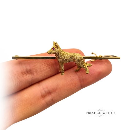 Solid 9ct gold Alsatian brooch featuring a textured dog design with red stone-set eye, 65mm gold tie pin with 26mm x 19mm dog figure, stamped and tested, heavy 7.95g weight, ideal for collectors or as a dog lover's statement accessory.