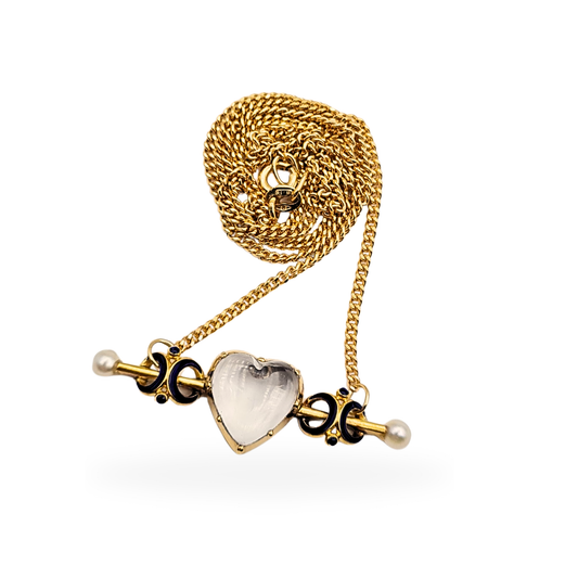 Antique mourning necklace featuring a 9ct gold curb chain with a 15ct gold heart-shaped locket pendant. Set with a quartz heart panel, pearl terminals, and blue enamel detailing. Measures 17 inches long, with a 40mm wide pendant, Victorian-era style.