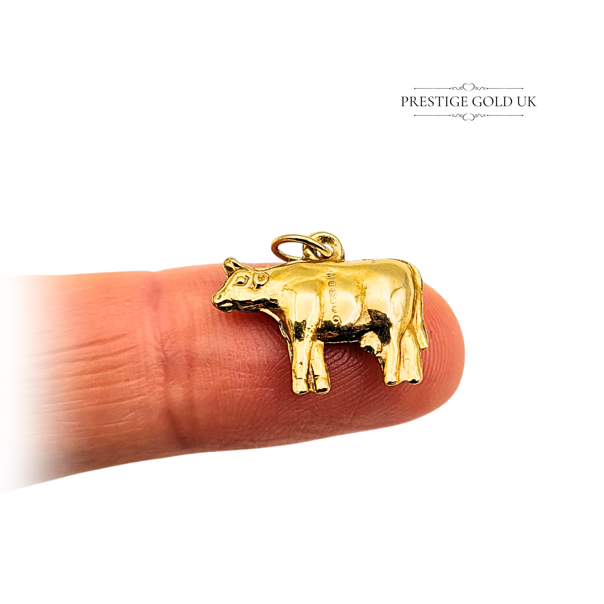 Vintage 9ct yellow gold cow charm, fully hallmarked London 1970. Puffy miniature animal design measuring 13mm long by 13mm tall, weighing 0.57g. Polished finish with jump ring attachment, ideal as a bracelet or necklace pendant.