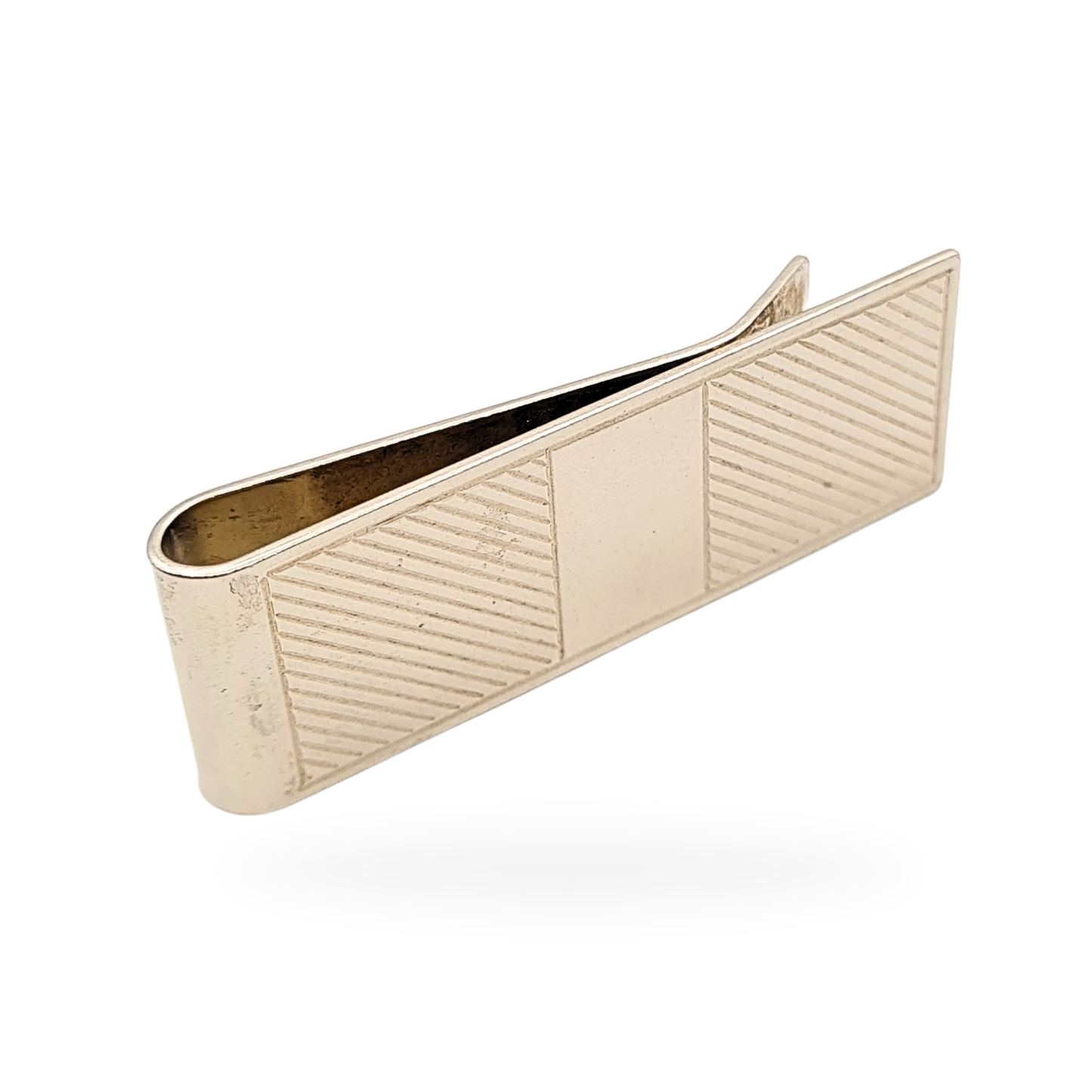 Close-up of a vintage sterling silver money clip with linear engraving and central plain panel, fully hallmarked Birmingham 1993, measuring 50mm long by 18mm wide, weighing 14.5g, classic men’s accessory or silver gift.