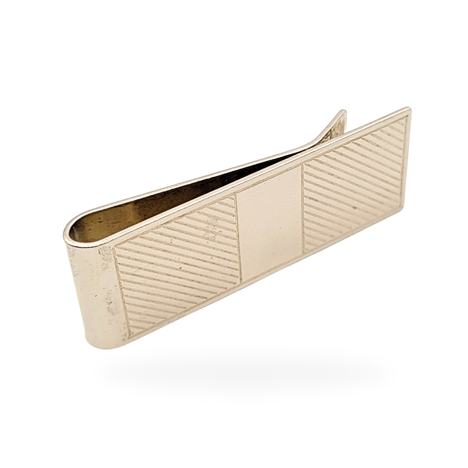 Close-up of a vintage sterling silver money clip with linear engraving and central plain panel, fully hallmarked Birmingham 1993, measuring 50mm long by 18mm wide, weighing 14.5g, classic men’s accessory or silver gift.