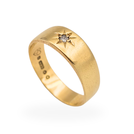 Vintage 9ct gold diamond gypsy ring with London hallmark dated 1968, wide 6.5mm band featuring a star-set single diamond. UK size Q 1/2 and US size 8 1/4, weighing 3.5g. Classic mid-century gold ring with traditional British hallmarking and timeless design.
