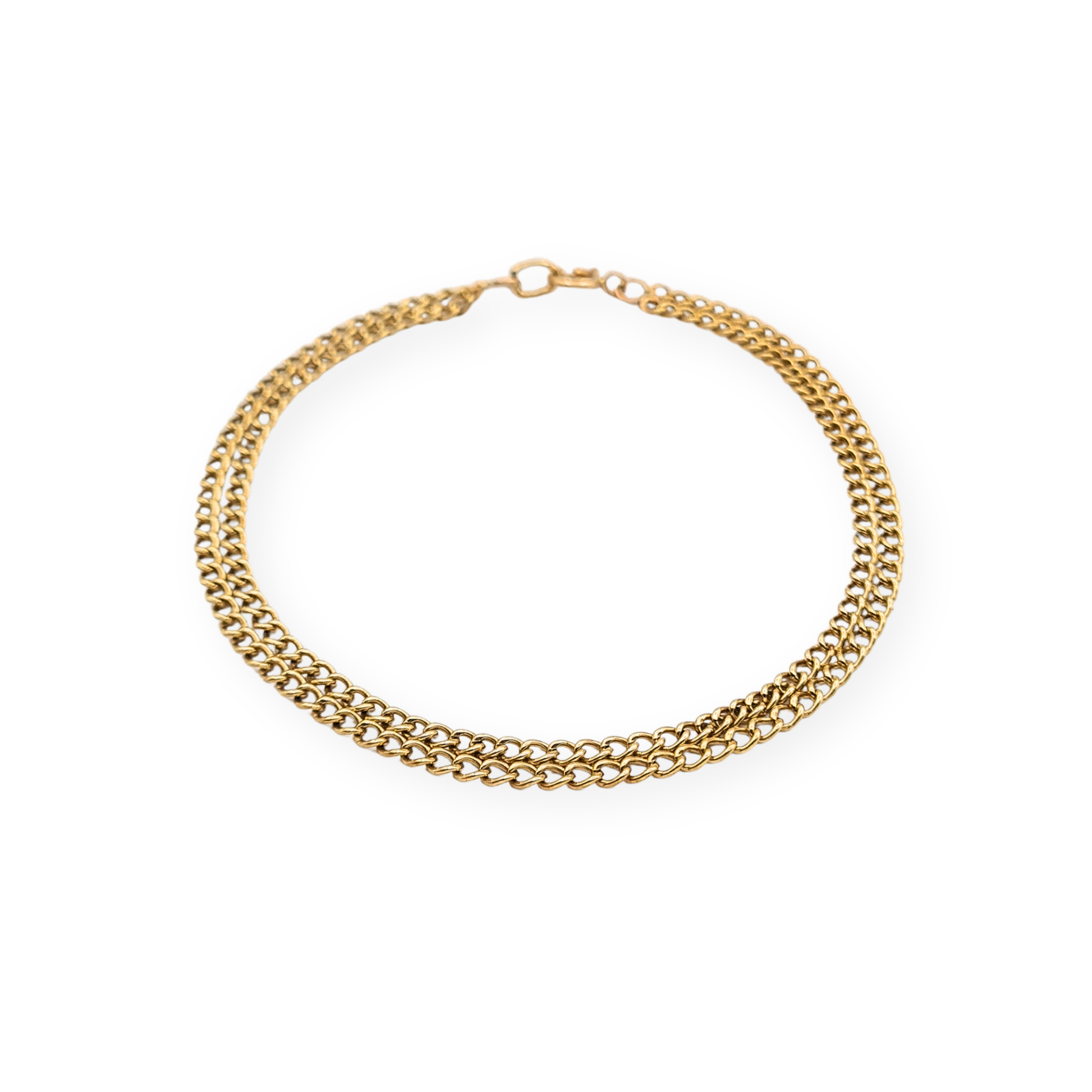 9ct yellow gold twin row curb chain bracelet measuring 7 1/4 inches (19 cm) long and 4mm wide, lightweight hollow link construction with classic spring ring clasp, stamped 9k and fully tested, delicate dainty gold bracelet suitable for everyday wear or layering.
