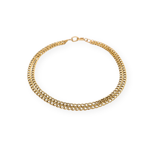 9ct yellow gold twin row curb chain bracelet measuring 7 1/4 inches (19 cm) long and 4mm wide, lightweight hollow link construction with classic spring ring clasp, stamped 9k and fully tested, delicate dainty gold bracelet suitable for everyday wear or layering.
