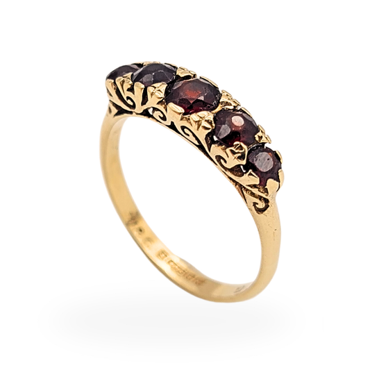 9ct gold vintage ring set with five deep red garnets in a graduated arrangement, approx 4.7mm wide band with ornate engraved shoulders, Birmingham 1972 hallmark, classic antique style gold band with visible gemstone wear