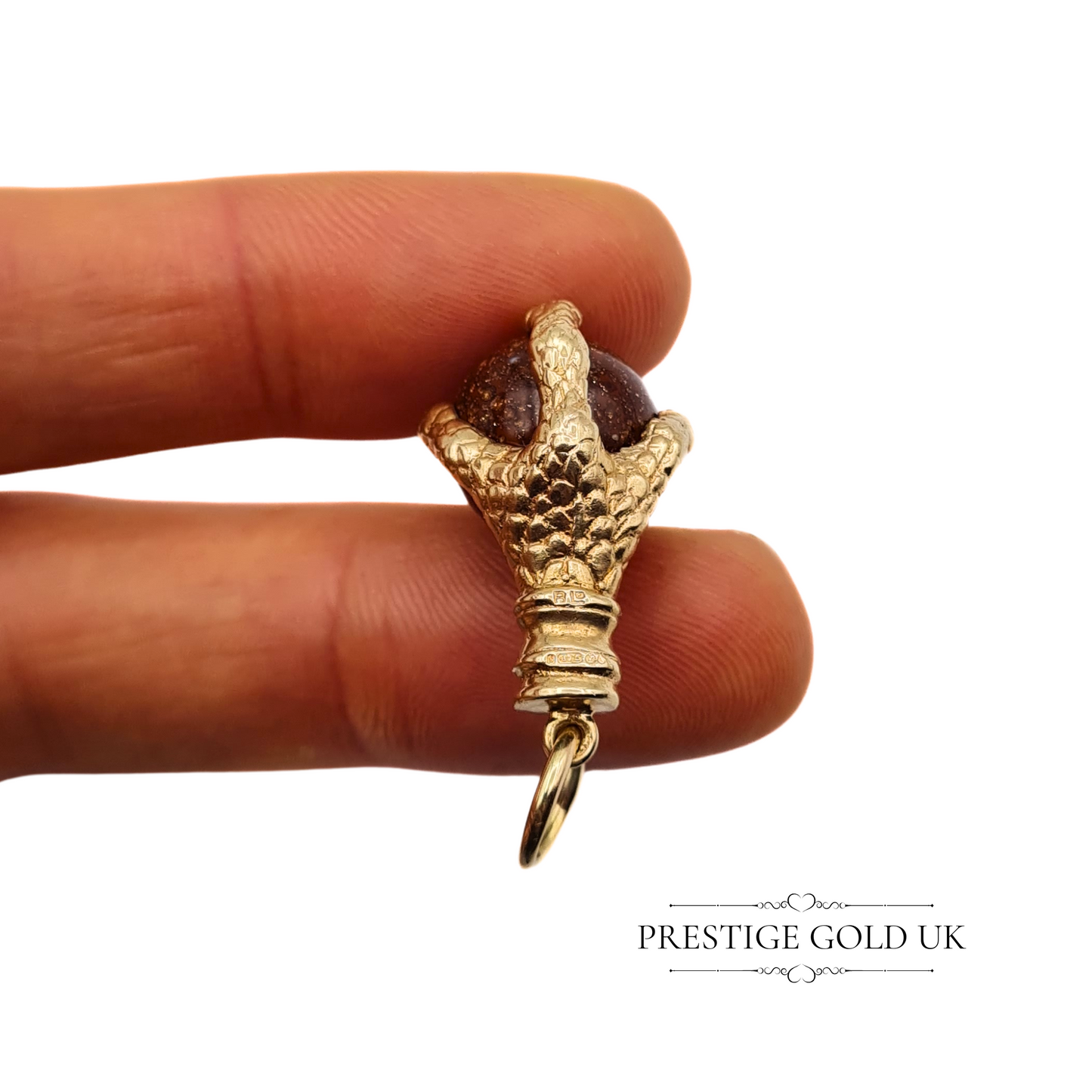 Hand-held vintage 9ct gold claw charm for scale, emphasising the charm’s 29mm height and craftsmanship.