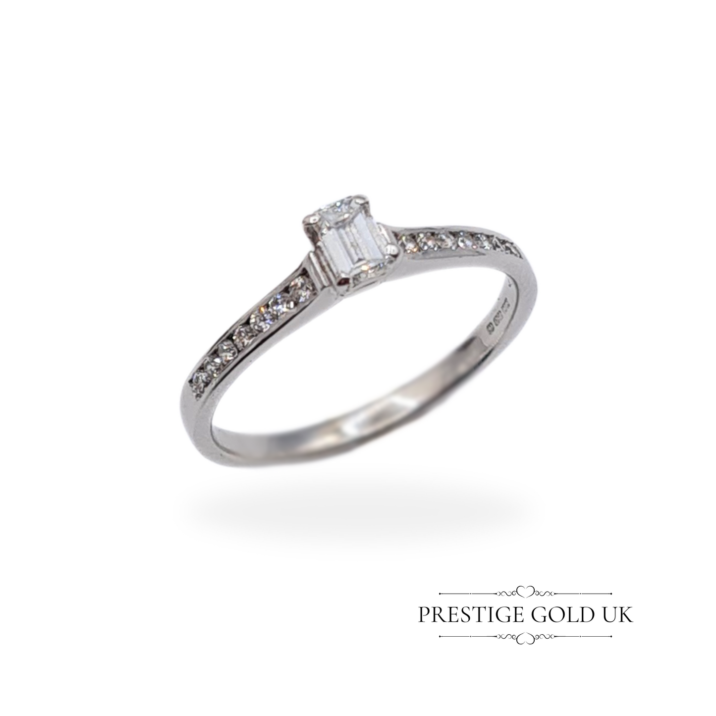 Exquisite 18ct white gold diamond ring displayed on a vintage jewellery box, fully refurbished and highlighting its 0.24ct baguette cut diamond.