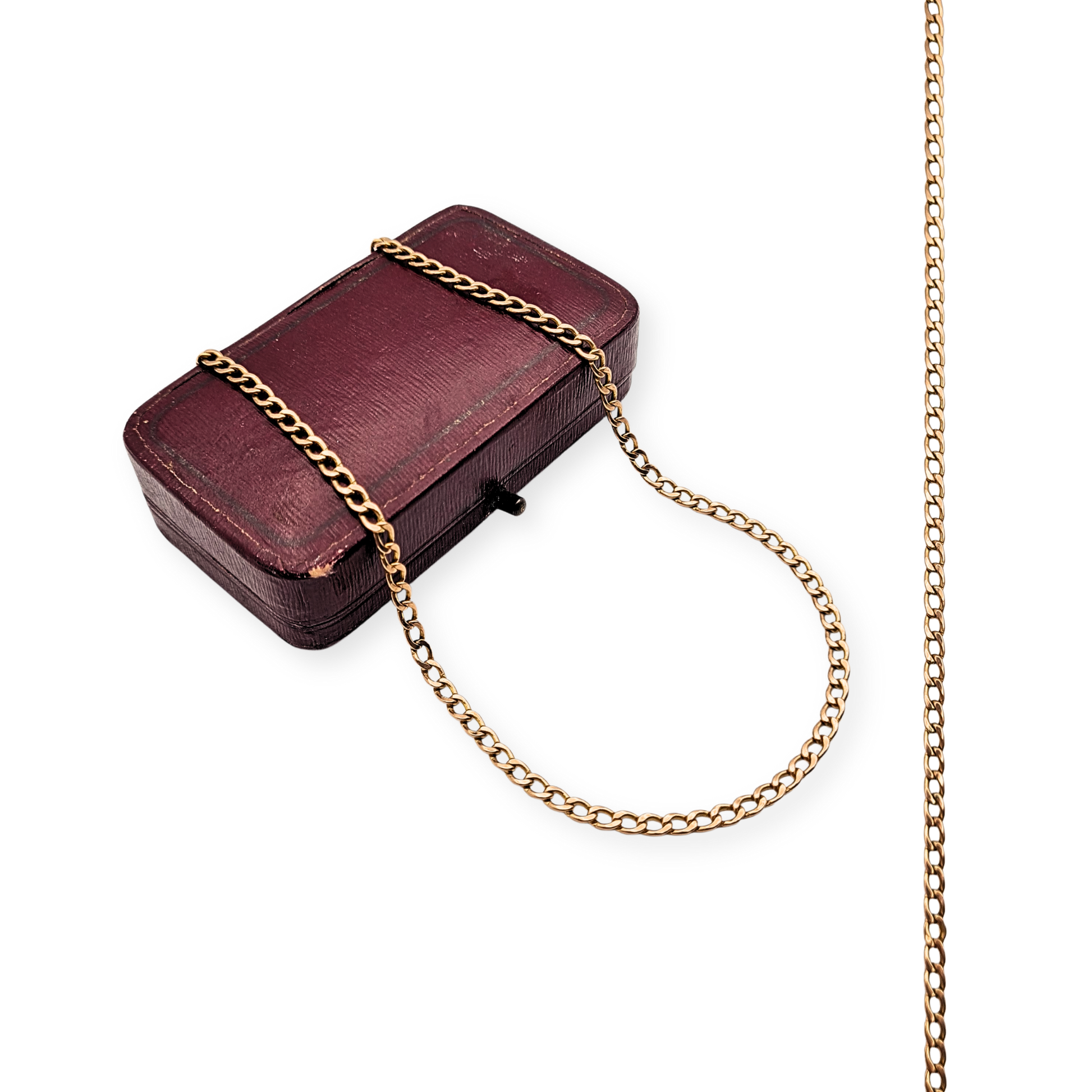 9ct rose gold curb chain necklace measuring 26 inches (66cm) long, fully British hallmarked 375 with a yellow gold lobster clasp. Lightweight hollow construction, 5.4g in weight, photographed with ruler and box for detail and scale.