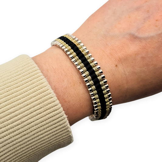 Sterling silver Links of London friendship bracelet with polished silver barrel links on black and gold fleck cord, adjustable sliding clasp, fully British hallmarked Edinburgh 2007, shown on wrist and ruler for scale and fit