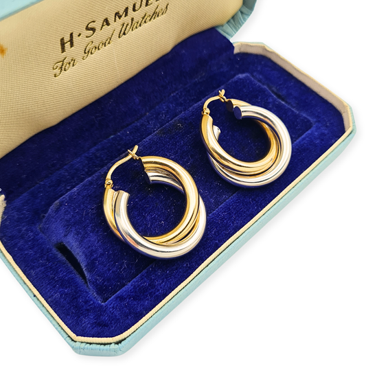 British hallmarked 9ct yellow and white gold chunky interlocking twist creole hoop earrings with flip-top fastenings.