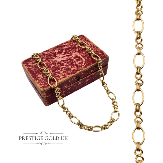 Vintage 9ct gold fancy link chain coiled on a textured red box, emphasising its ornate twist oval link design.