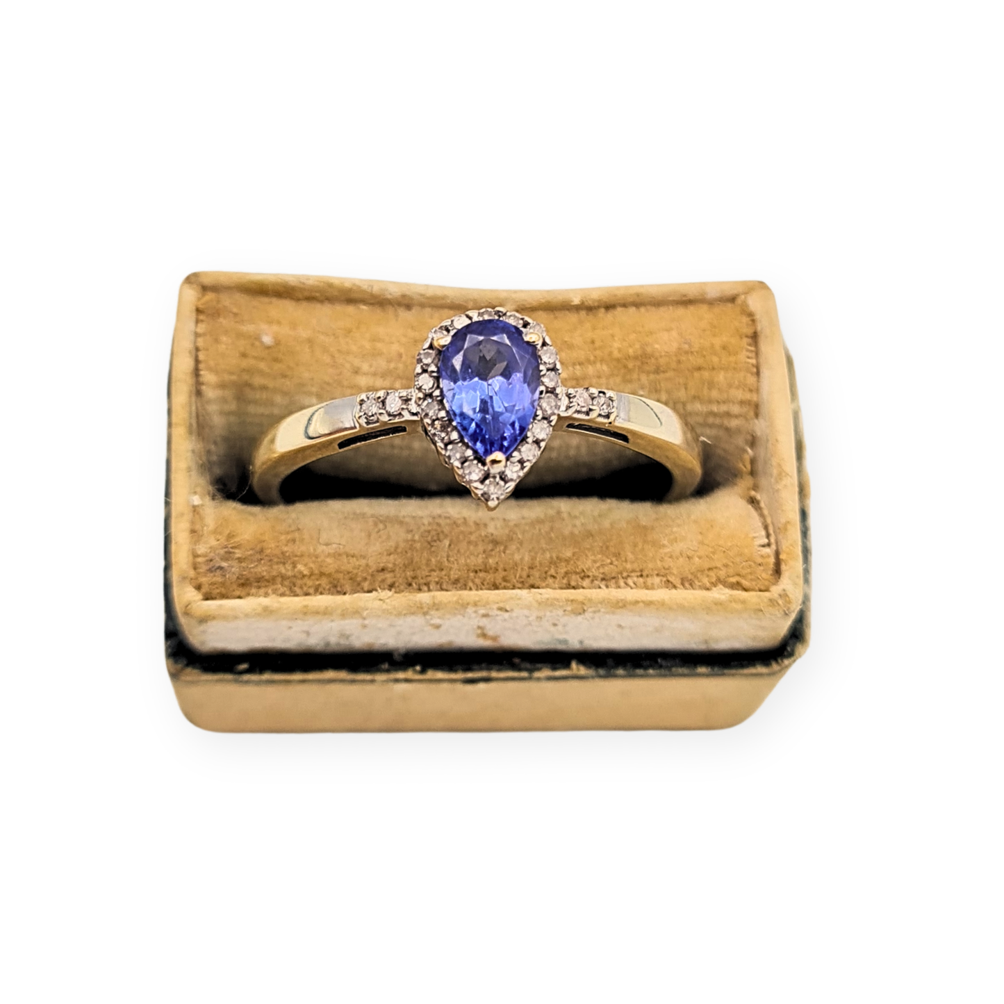 9ct white gold ring featuring a pear cut blue tanzanite surrounded by a diamond halo, approx 8.5mm head size, fully British hallmarked, slim polished band with delicate shoulder set stones, elegant fine jewellery piece