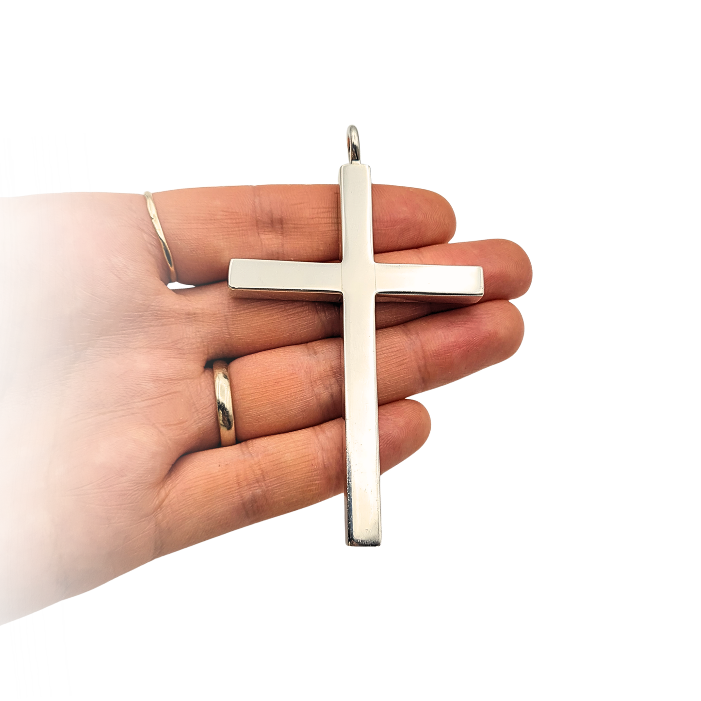 Large solid sterling silver cross pendant measuring 8.3cm by 5cm and 6mm thick, heavy 45.5g weight, polished finish with Sheffield 1992 hallmark, shown against ruler and in hand to demonstrate scale and substantial size