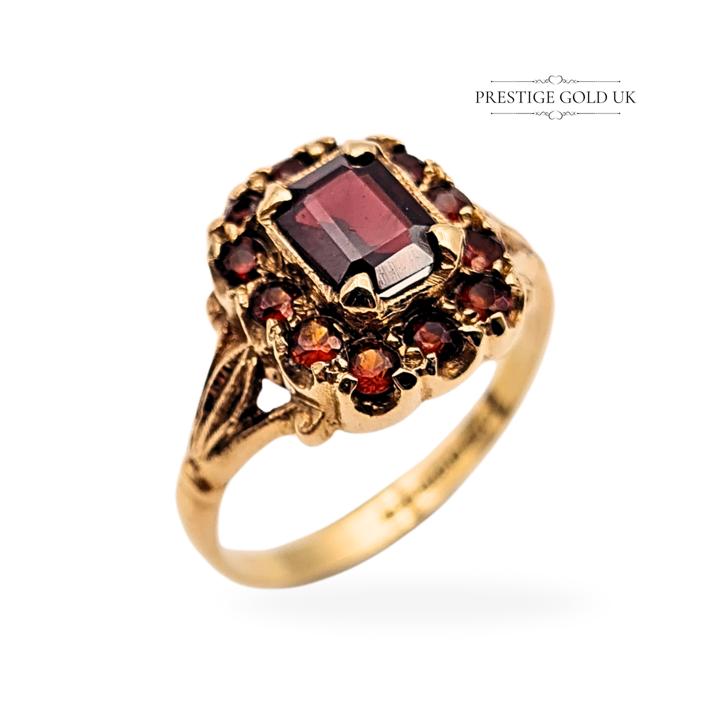 9ct gold garnet cluster ring with baguette-cut centre stone, surrounded by smaller round garnets in ornate Victorian-style claw setting, hallmarked Birmingham 1968, size UK O 1/2 US 7 1/4, weighing 3.1g, elegant vintage design.
