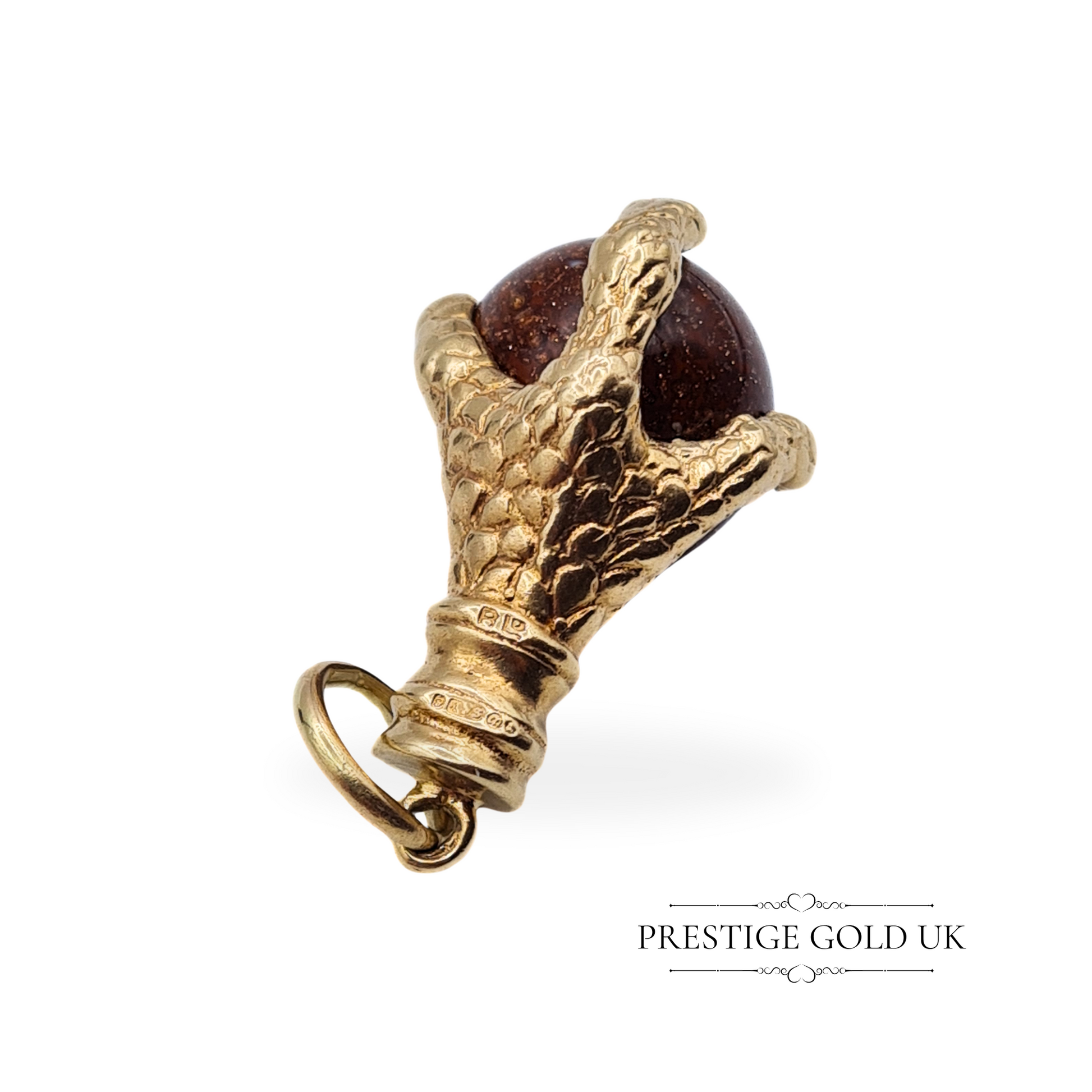 Top-down view of the vintage eagle claw pendant, showing its intricate gold hallmark from London 1967.