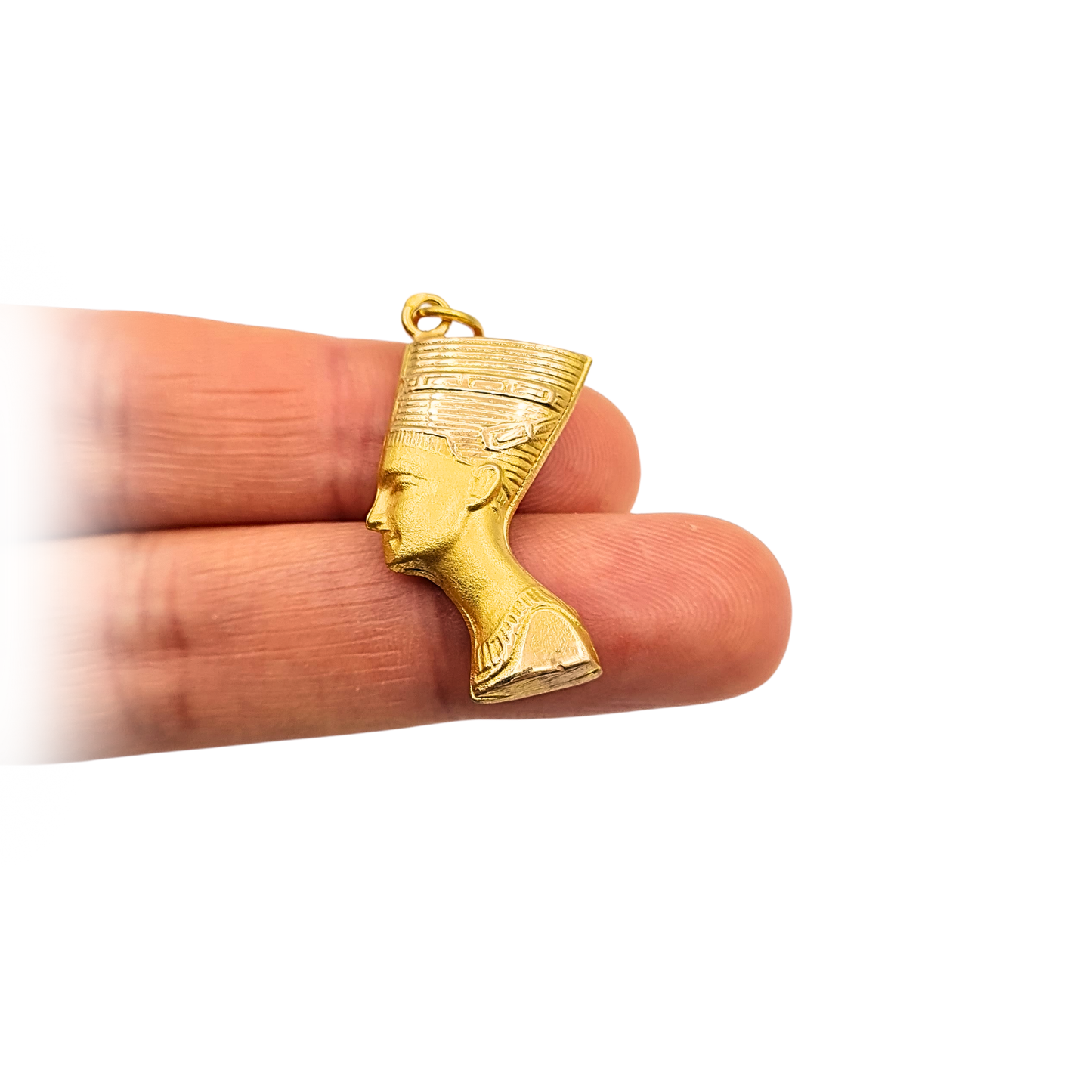 18ct yellow gold Egyptian Nefertiti head pendant with detailed pharaoh bust design, stamped and tested 750 gold. Hollow construction charm measuring 30mm tall and 16mm wide, warm satin finish, collectible ancient-inspired gold jewellery.
