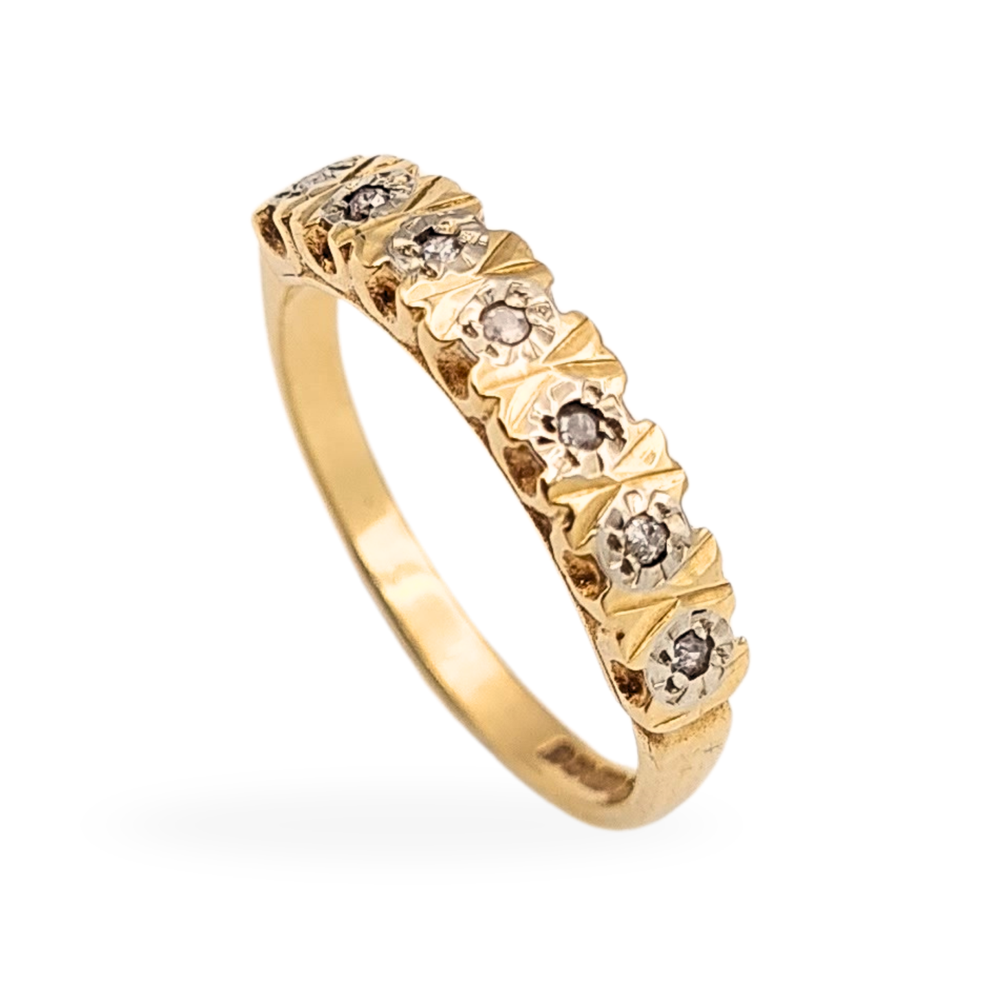 Vintage 9ct gold seven-stone diamond ring, fully hallmarked Birmingham 1979, UK size L 1/2 (US 6). Features seven round-cut diamonds in engraved gold settings with white gold highlights. Elegant vintage yellow gold band, 2.25g.