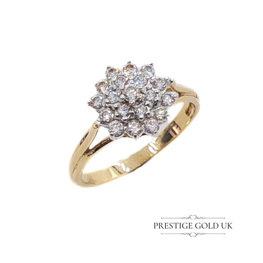 A 9ct gold ring featuring a 3-tier cluster design with cubic zirconia stones set in white gold, paired with a yellow gold band. The ring is fully British hallmarked