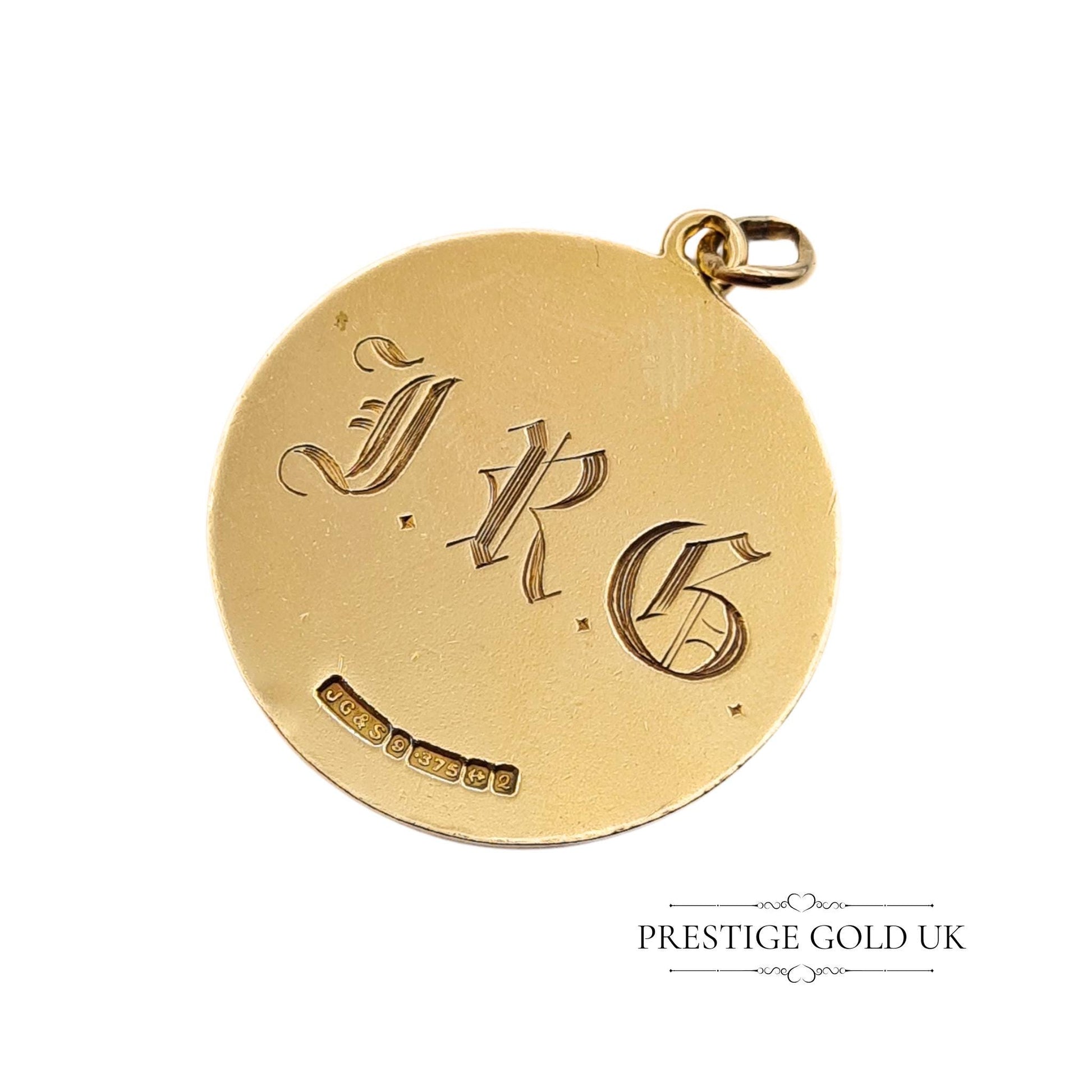 Close-up of 1965 Birmingham hallmarks on a vintage St Christopher pendant, confirming authenticity.