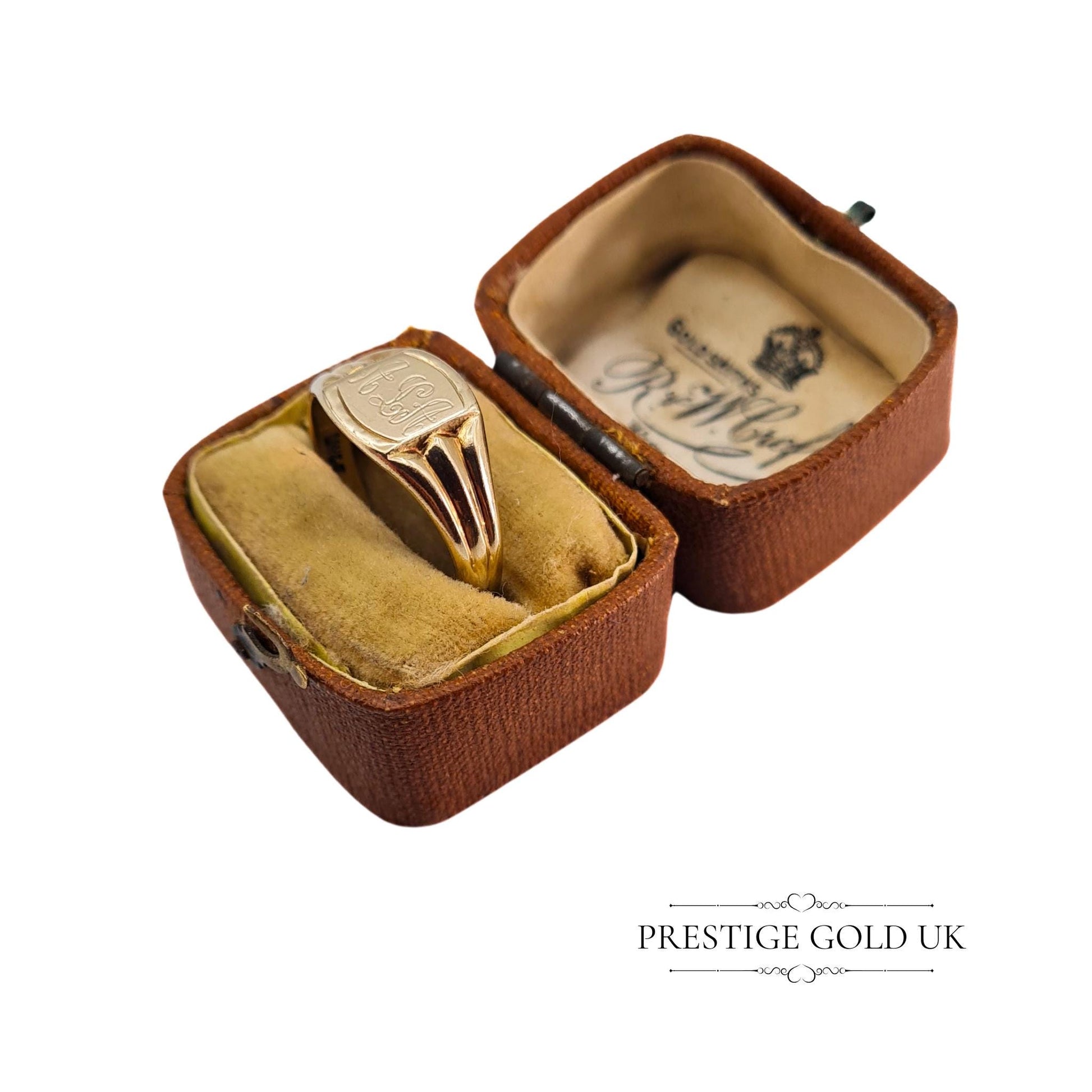 Vintage signet ring displayed in a vintage brown jewellery box, highlighting its unique charm and engraving.