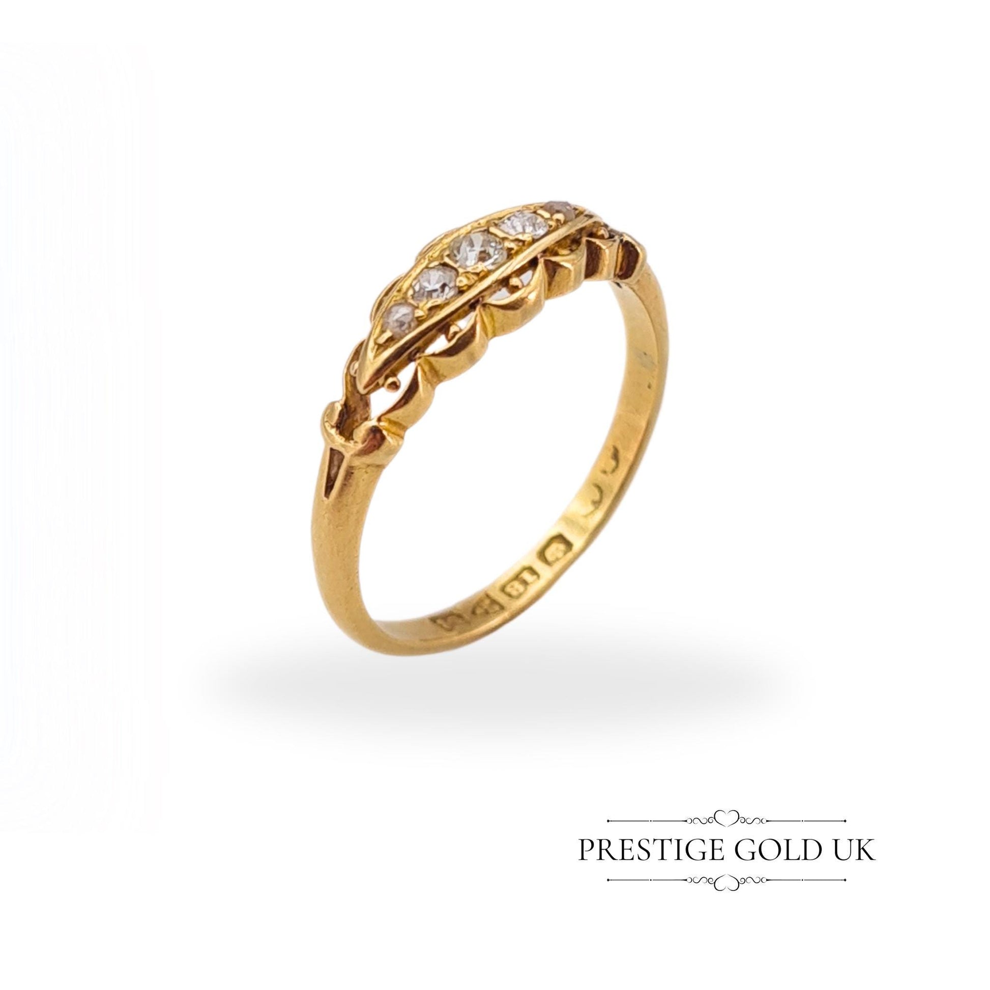 Close-up of an 18ct gold Georgian ring showcasing intricate gallery work and sparkling old-cut diamonds.