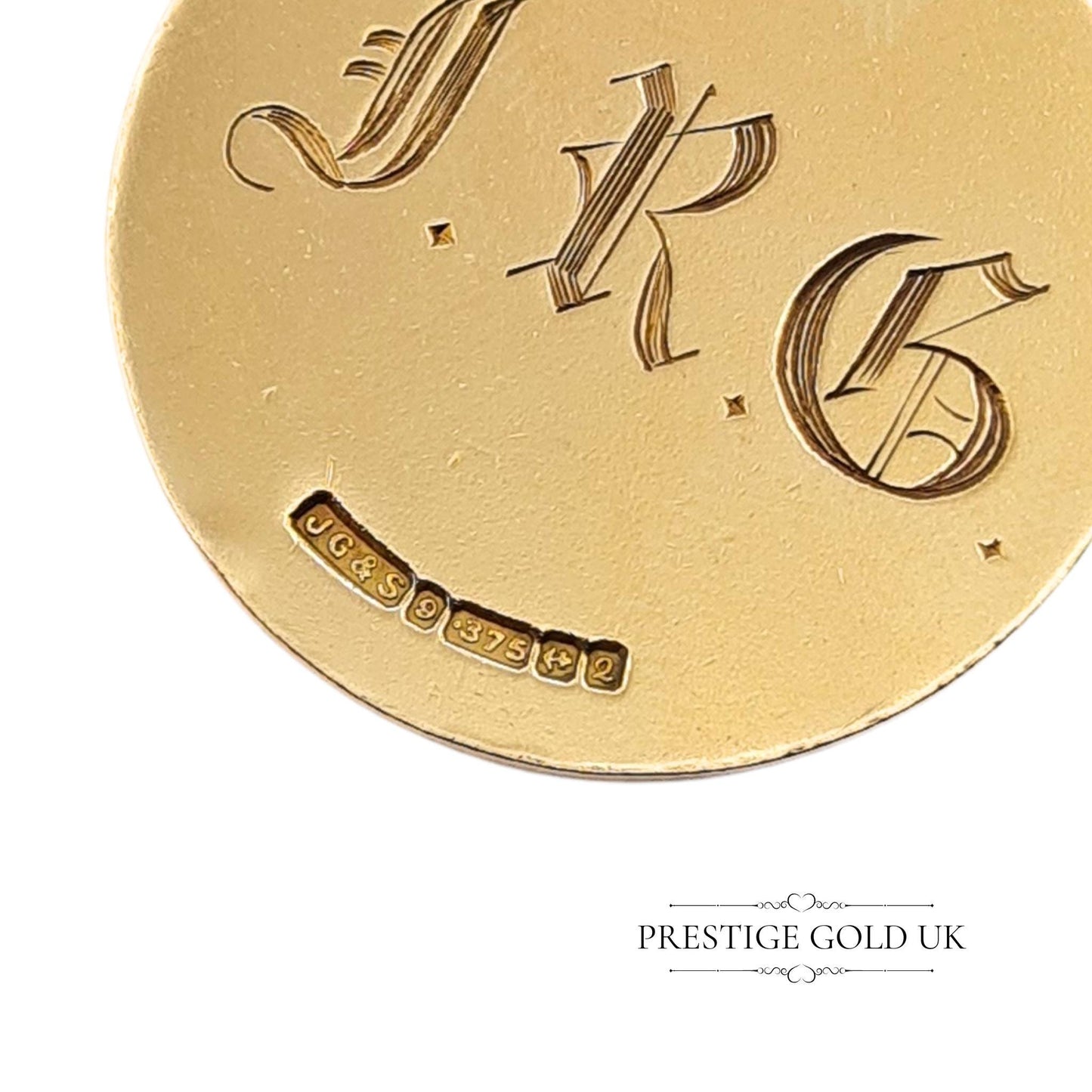 Close-up of 1965 Birmingham hallmarks on a vintage St Christopher pendant, confirming authenticity.