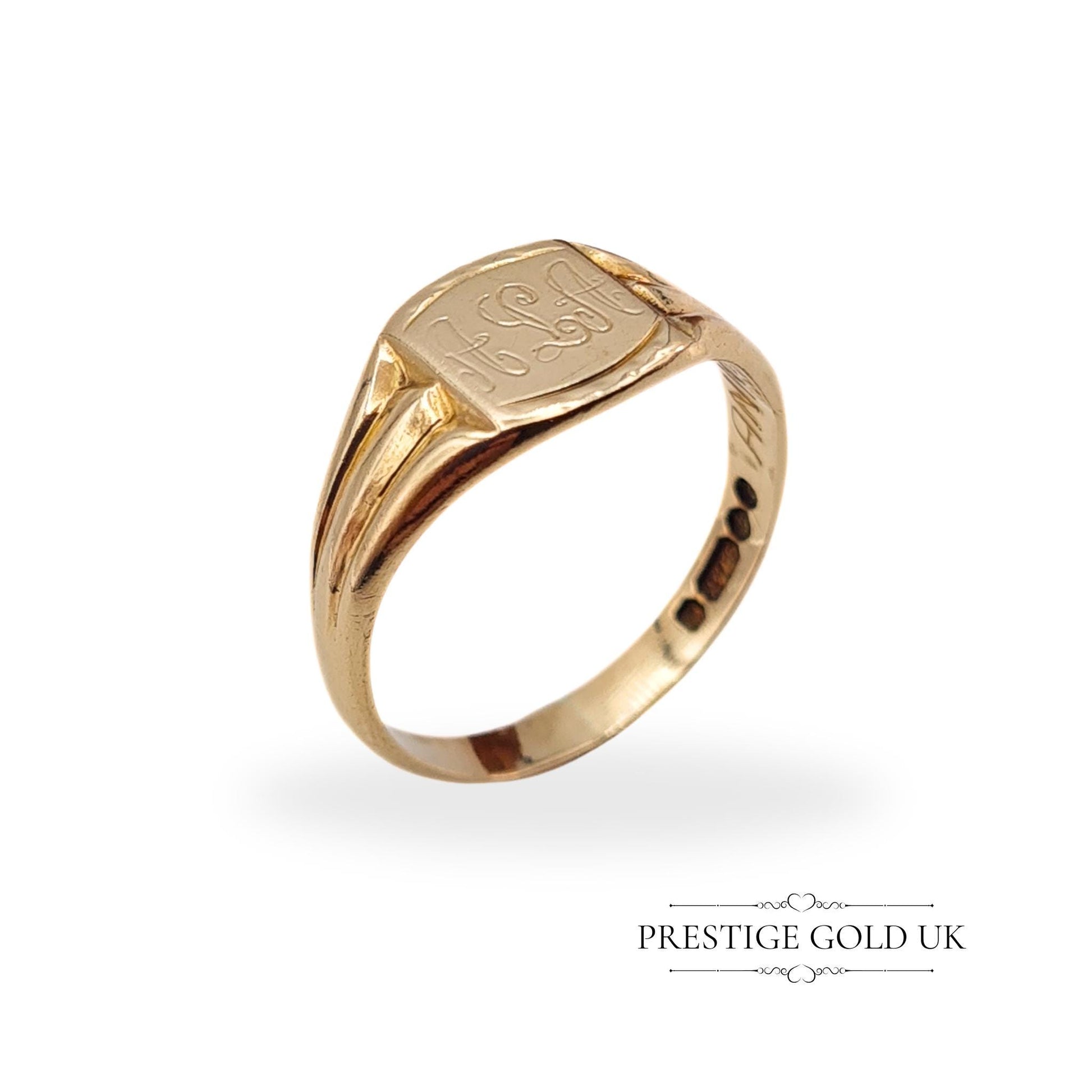 Close-up of a 9ct gold signet ring, showcasing its delicate engraving and smooth, polished finish.